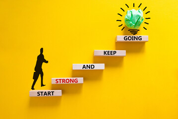 Start strong and keep going symbol. Concept words 'Start strong and keep going' on wooden blocks on...