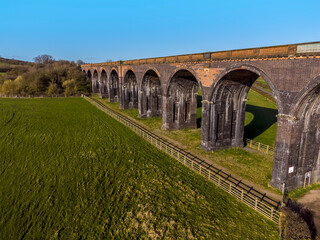 Fototapeta premium A view of ten of the eighty two arches forming the Welland Valley Viaduct on a bright sunny spring day 
