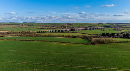 The Harringworth Viaduct stretches across the wide span of the Welland Valley on a bright sunny spring day 