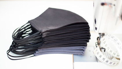 Antivirus mask made of cotton. Gray and black face mask during a virus COVID-19. Handmade face masks.