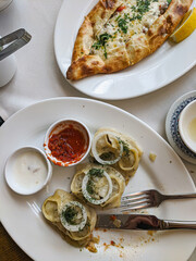Manty dumplings and Kasarli Pide boat-shaped flatbread with cheese, sauce spices and herbs
