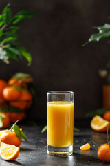 A glass of orange juice on dark background