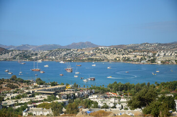 Fototapeta na wymiar Beautiful marine landscape. Panorama View from the hill to the Gumbet bay in sunny day. Bodrum, Turkey