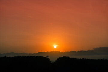 Fototapeta premium Blue sky background with little clouds, morning sun rising up. In Phuket, Thailand