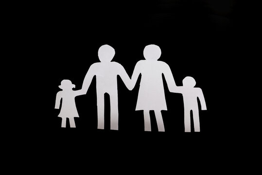 paper silhouette of a family on a black