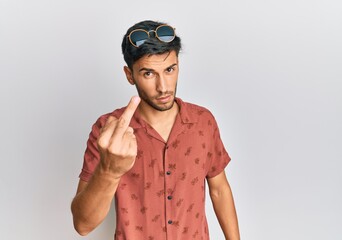 Young handsome man wearing casual summer clothes showing middle finger, impolite and rude fuck off expression