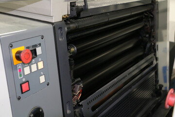 Black painted roller system of the printing machine in Matbaa. Komori lithrone. selective focus