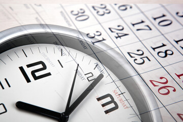 large white clock face with calendar sheets