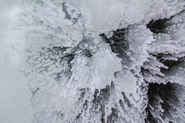 Ice Grotto with Icicles at Baikal Lake in Russia
