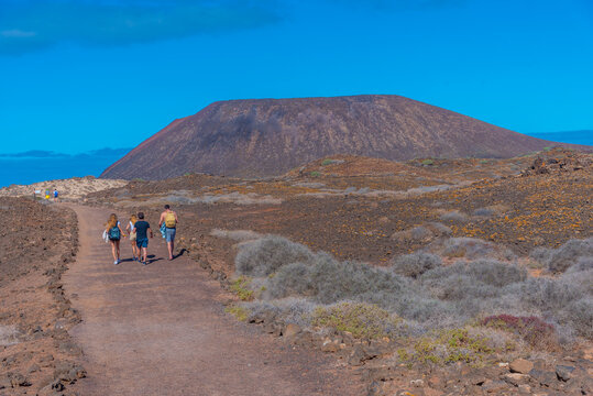 People are walking towards Cadera at Isla de Lobos, Canary islands, Spain
