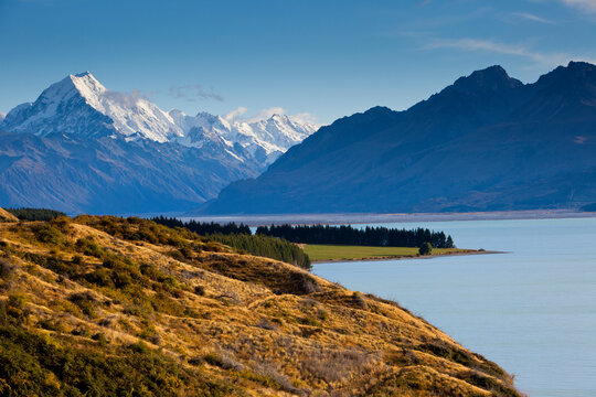 Early morning sun lights the summit of Aoraki / Mt. Cook and adjacent peaks in New Zealand's Southern Alps in Aoraki/Mt. Cook National Park in the South Island.  
