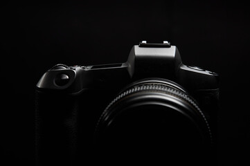 professional digital photo camera against black background