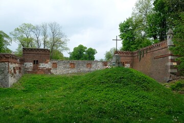 Fototapeta na wymiar Ruins of palace and insurgent mound with a cross in Pilica, Krakow-czestochowa Upland, Silesia, Poland