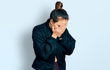 Young hispanic girl wearing sportswear with sad expression covering face with hands while crying. depression concept.
