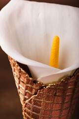 a white flower in a golden cone 