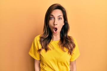Young latin woman wearing casual clothes afraid and shocked with surprise expression, fear and excited face.