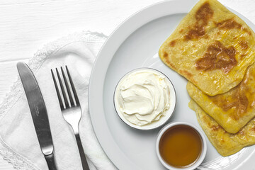 Homemade rghaif or msemen Arab with honey and cream cheese