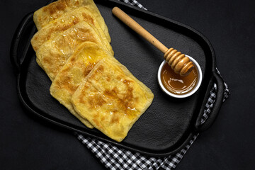 Homemade rghaif or msemen Arab with honey and cream cheese