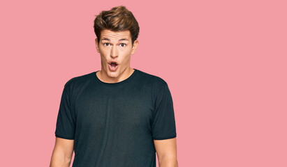 Obraz premium Handsome caucasian man wearing casual clothes afraid and shocked with surprise expression, fear and excited face.