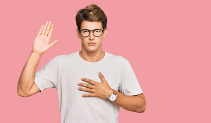 Handsome caucasian man wearing casual clothes and glasses swearing with hand on chest and open...