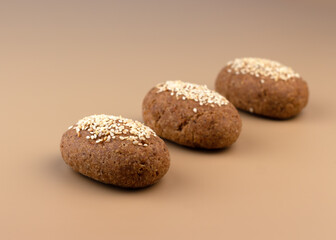 A healthy gluten-free keto bread made from almond flour and psyllium husk, sprinkled with sesame seeds. Baking ingredients in scoops. Ketogenic diet, paleo, low carb, high fat.