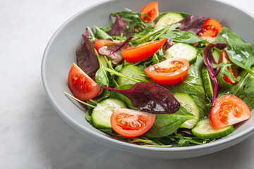 Healthy fresh salad of vegetable cucumber, tomato, spinach, arugula