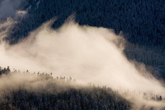Clouds swirl as they rise off the valley floor below Elfin Lakes Hut in Garibaldi Provincial Park, British Columbia, Canada.   