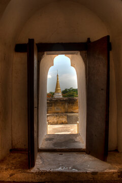 View through a window at the Maha Aung Mye Bon Zan Monastery in the ancient city of Ava in the country of Burma (Myanmar)    