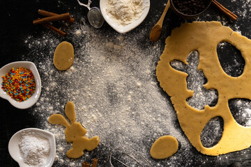 Making cookies for Easter. Bunny cut out of the dough. Traditional Easter bunny and eggs. Copy space
