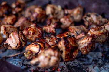 Fresh shish kebab on skewers is fried on the grill. Grilled meat on skewers.