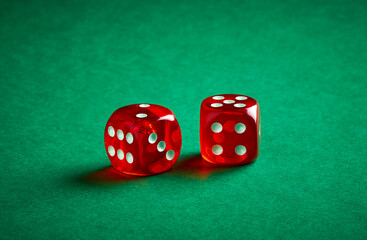 Two red dices on green casino table background