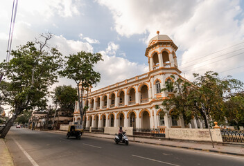 Fototapeta na wymiar An old colonial era building with vintage architecture in the city of Mysuru.