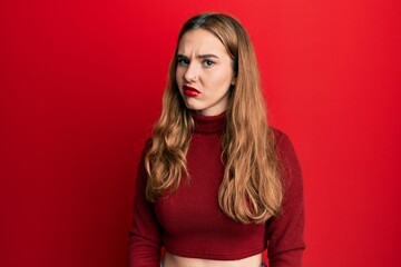 Fototapeta premium Young blonde woman wearing turtleneck sweater skeptic and nervous, frowning upset because of problem. negative person.