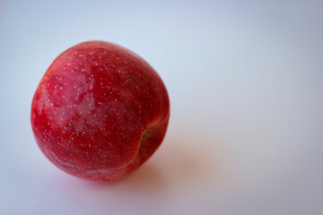 Red apple stand on a white surface