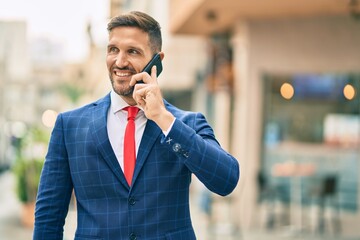 Young caucasian businessman smiling happy talking on the smartphone at the city.
