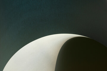 Macro image of dark grey paper with shadow effect and selective focus.
