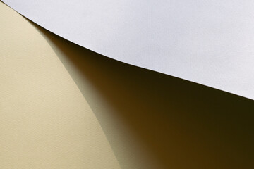 Macro image of grey and yellow paper with shadow effect and selective focus.