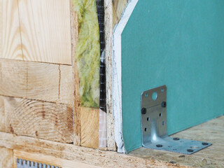 mineral insulation in the wooden wall of the house frame construction