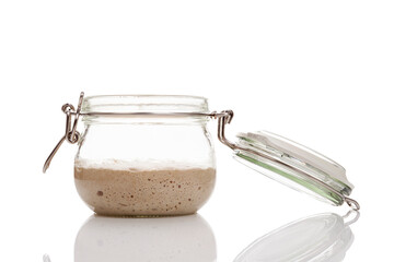 Active sourdough starter in a glass jar for homemade bread.