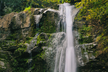 Fototapeta na wymiar waterfall in the mountains. wild waterfall and rock