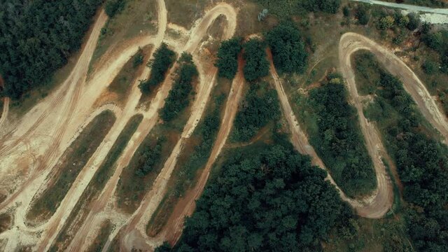 Rugged terrain for motorcycle racing, filmed with a drone from above, slow movement down