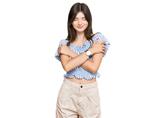 Fototapeta premium Young beautiful caucasian girl wearing casual clothes hugging oneself happy and positive, smiling confident. self love and self care