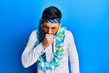 Young hispanic businessman wearing party funny style with tie on head feeling unwell and coughing as symptom for cold or bronchitis. health care concept.