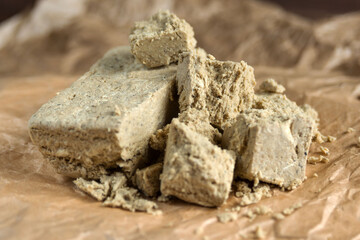Delicious oriental dessert sunflower halva on craft paper. Close-up.