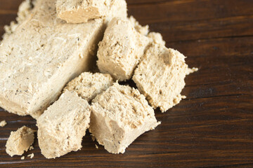 Delicious oriental dessert sunflower halva on a dark background. Closeup.