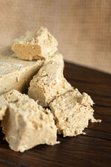 Delicious oriental dessert sunflower halva on a dark background. Closeup.