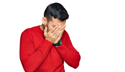 Young hispanic man wearing casual clothes with sad expression covering face with hands while crying. depression concept.