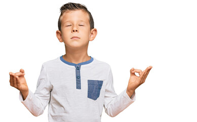 Adorable caucasian kid wearing casual clothes relax and smiling with eyes closed doing meditation gesture with fingers. yoga concept.