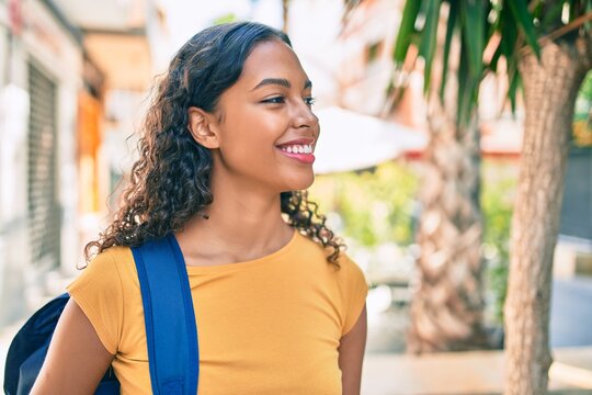 Young african american student girl smiling happy walking at university campus.