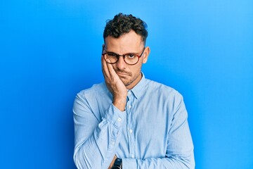 Young hispanic man wearing casual clothes and glasses thinking looking tired and bored with depression problems with crossed arms.